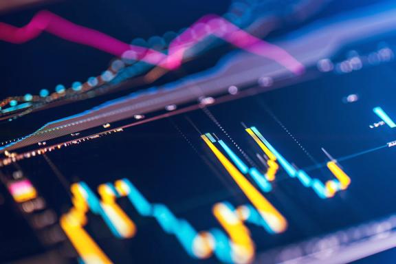 Close-up of digital trading charts with candlestick patterns and moving average lines