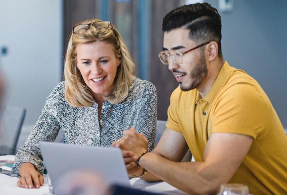 Man and woman looking at laptop together