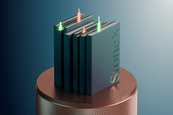 Books on a pedestal with green and red candlesticks poking out the top on a teal background 