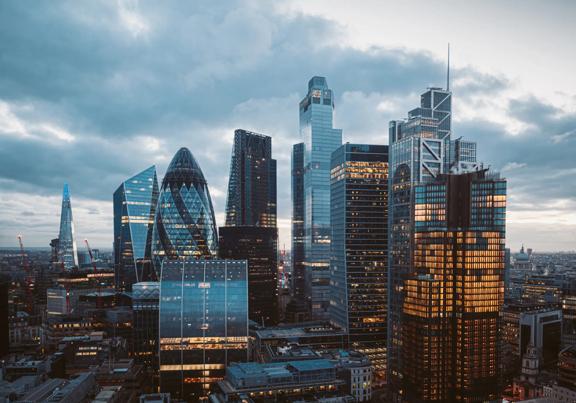 London skyline featuring modern skyscrapers including the Gherkin and the Shard at dusk