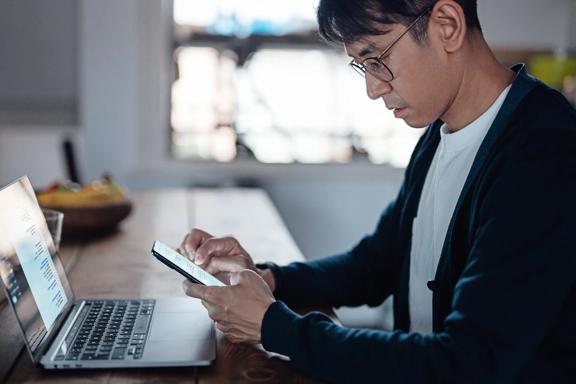 Professional managing investments across mobile and desktop devices