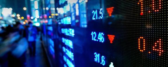 Close-up of a digital stock market ticker showing market data with price fluctuations