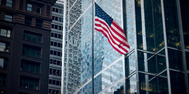us flag in the middle of buidlings