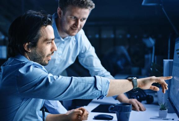 Two men looking at computer screen