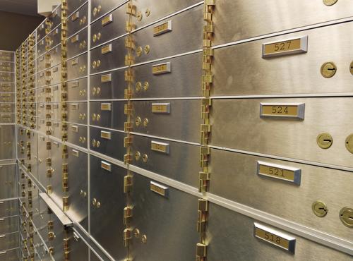 Secure metal safety deposit boxes inside a financial institution vault, representing StoneX’s commitment to trusted B2B financial services and asset protection.
