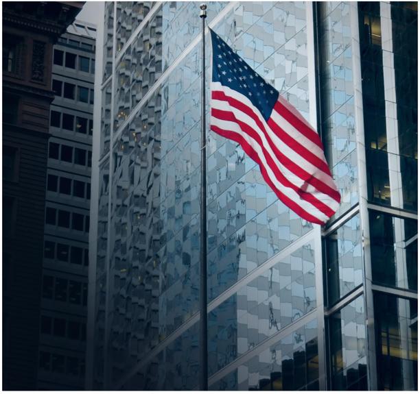 American flag outside a financial district building.