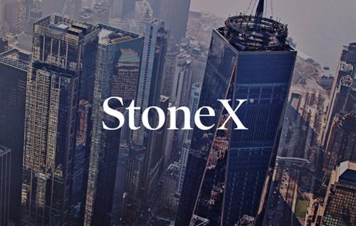 Aerial view of modern skyscrapers in a financial district with StoneX logo overlay