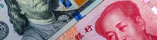 Close-up of Chinese yuan currency alongside US dollar, symbolizing global currency exchange and trade tensions
