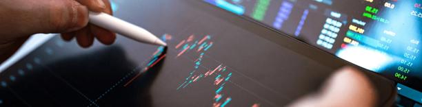Person using digital tablet showing stock chart, symbolizing financial trading analysis