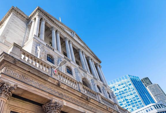 Historic financial institution building with modern skyscrapers in the background, symbolizing Swift compliance and evolving financial standards.

