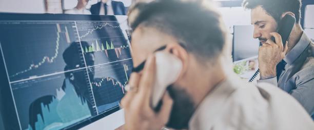Financial brokers on phone calls coordinating market activity