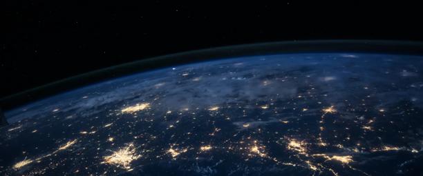 View of Earth from space showing illuminated cities and global connectivity at night