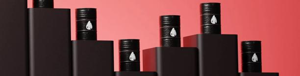 Black oil barrels arranged in rows, representing crude oil storage and energy markets