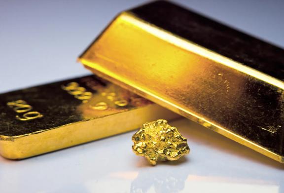 Close-up of gold bars and a nugget, representing precious metals and investment opportunities