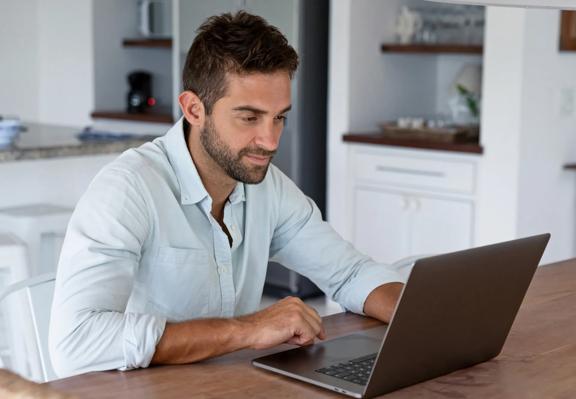 Professional man working on a laptop from at home