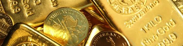 Assortment of gold coins and bullion bars stacked together, symbolizing safe-haven investment and global gold demand