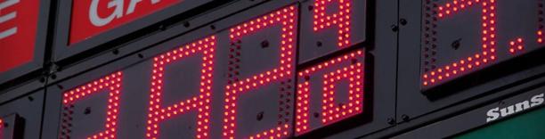 Electronic red LED board displaying rising numbers, symbolizing inflation and price growth in financial markets