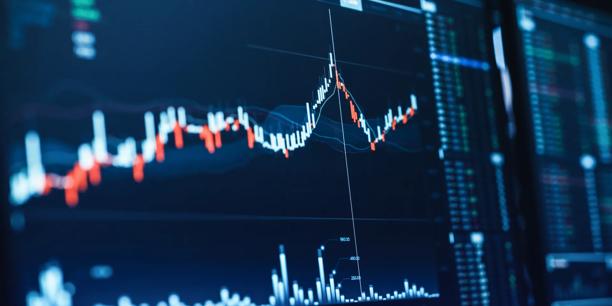 Close-up of a digital financial chart showing a rising price line, candlestick patterns, and market data on a trading screen.