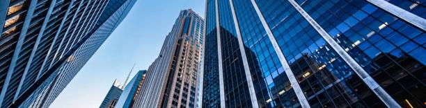 Cluster of international office towers with sleek architecture, illustrating worldwide finance and capital markets