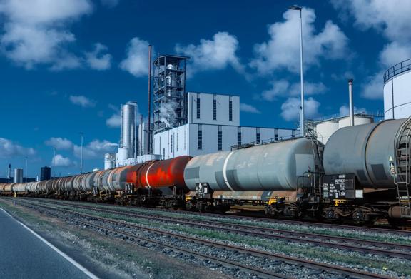 Industrial oil refinery with large storage tanks and production machinery.