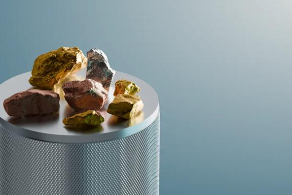Unrefined metals on a circular platform against a teal background