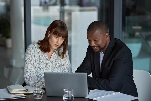 Colleagues reviewing financial documents during a meeting
