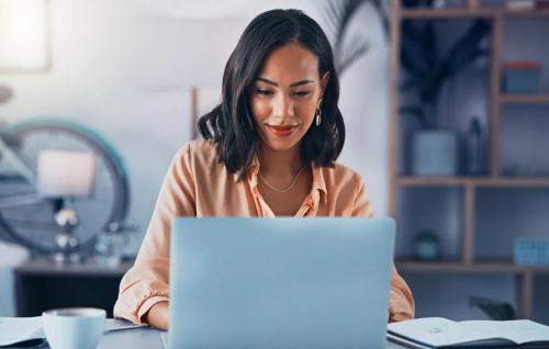 Relaxed woman working on laptop 