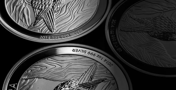 2014 one-ounce silver coins with 999 purity featuring a feathered design and wood grain background