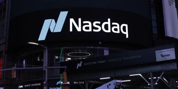 Nasdaq logo displayed on a digital billboard at a stock exchange venue, representing financial markets and securities trading.