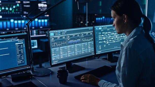 Financial experts overseeing clearing systems on multi-monitor setups in a secure environment