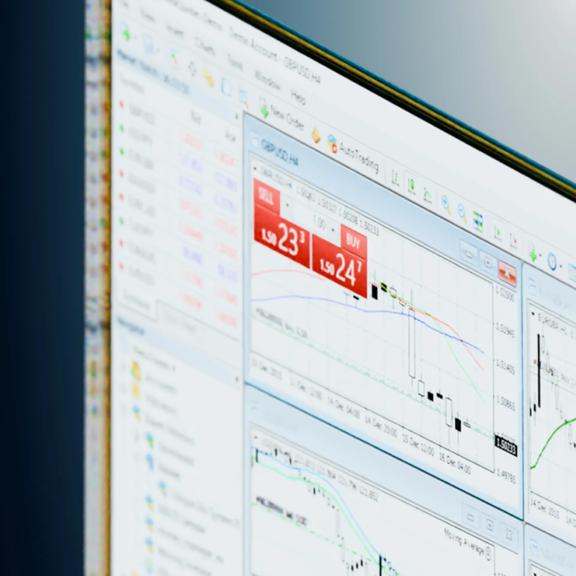 Trading platform screen showing live buy and sell prices over a candlestick chart
