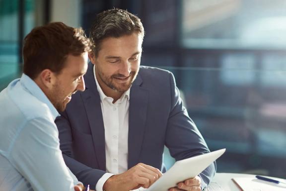 Two professionals reviewing financial documents during a business meeting