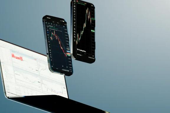 Trading platform in light theme on a laptop and on two smartphones in dark mode