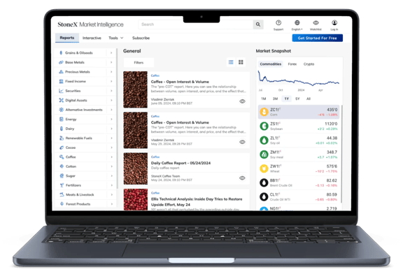 StoneX Market Intelligence dashboard on laptop showing coffee market reports and live commodity pricing trends