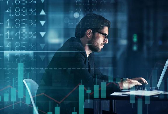  Man wearing glasses working at laptop