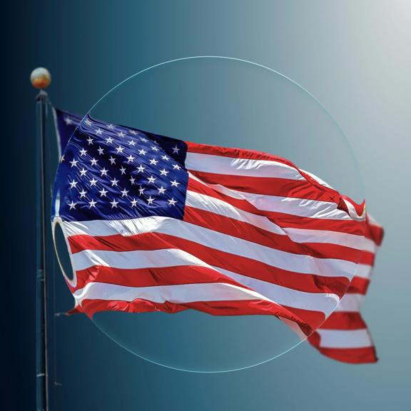Magnifying glass over US flag on a teal background