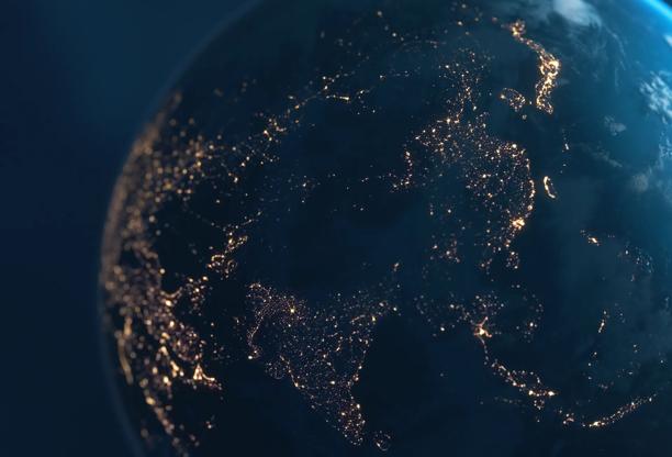 View of Earth from space showing illuminated cities at night across Asia and the Middle East