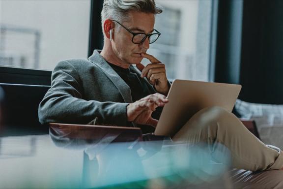 Professional analyzing financial data on a laptop