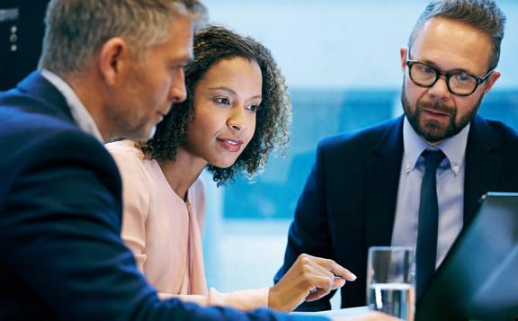 Team of business professionals collaborating on project strategy at office table