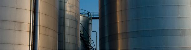 Close-up of large metal storage silos at an industrial facility.