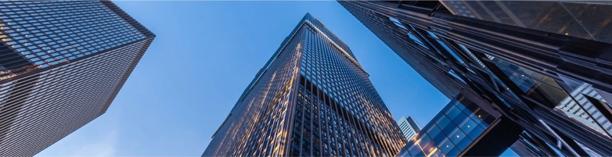 Tall modern skyscrapers with reflective glass facades, representing the strength and scale of global banking institutions