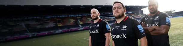 Saracens rugby players with StoneX branded shirts in action during a game, highlighting sports partnership and sponsorship branding
