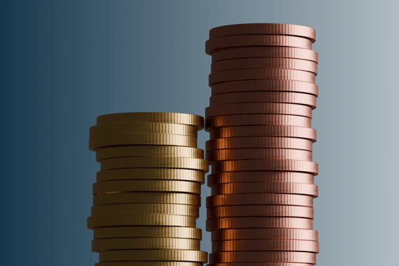 Two stacks of metallic coins arranged at different heights against a blue background. Financial growth concept representing investment performance, wealth building, savings, and capital accumulation.