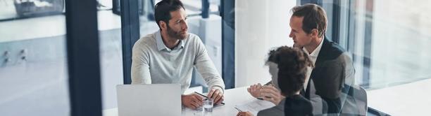 Financial professionals in a meeting, representing StoneX Digital’s tailored digital asset management solutions for family offices.