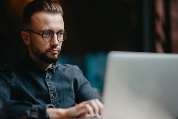 Business professional working on a laptop in a modern office environment