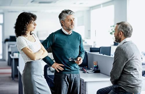 Team of business professionals having a discussion in a modern office environment