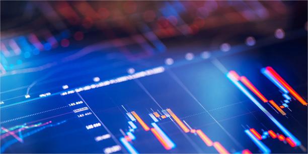 Close‑up of a digital trading chart with colourful candlesticks and data lines on a dark screen.