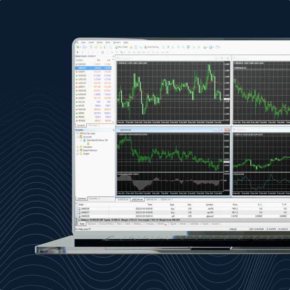 A laptop displaying a trading platform with four market charts showing price movements and technical indicators.