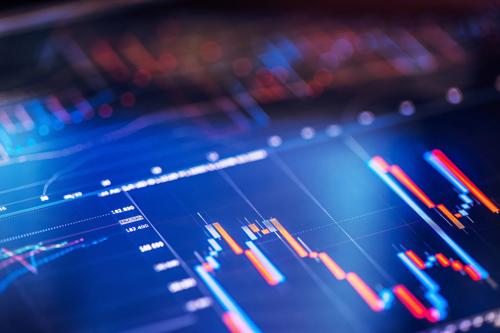 Blue digital candlestick chart with blurred area
