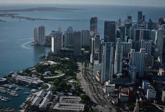 Aerial view of downtown Miami skyline with waterfront, marina, and financial district high-rises
